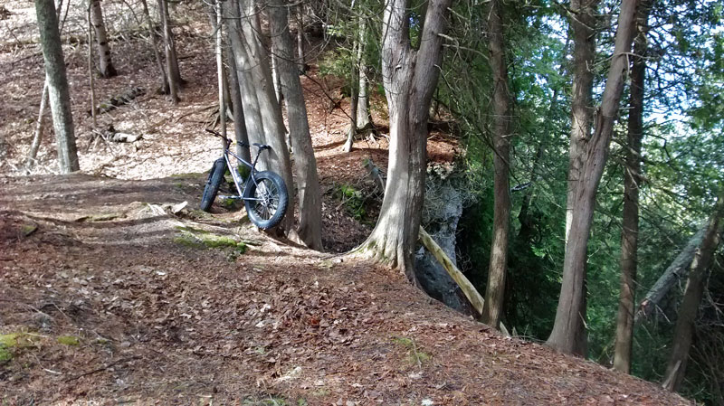 mountain biking by cliff on the tranquil bluff trail